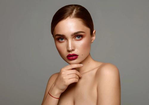 close-up-portrait-of-young-female-model-with-red-lips-isolated-on-gray-background-small.png